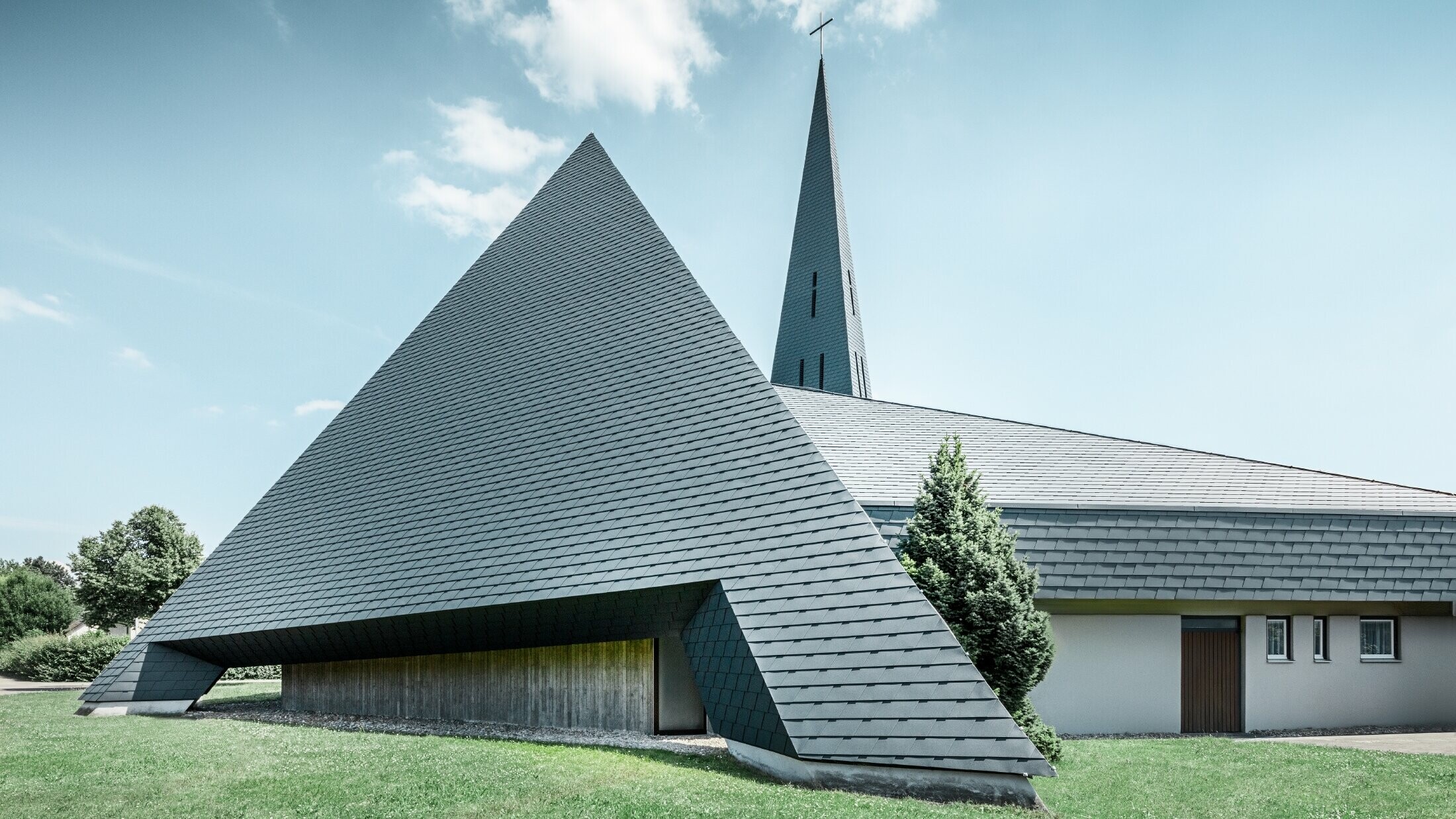 katholische Kirche in Langenau mit einem Design ähnlich einer Pyramide eingedeckt mit PREFA Aluminiumschindeln in anthrazit