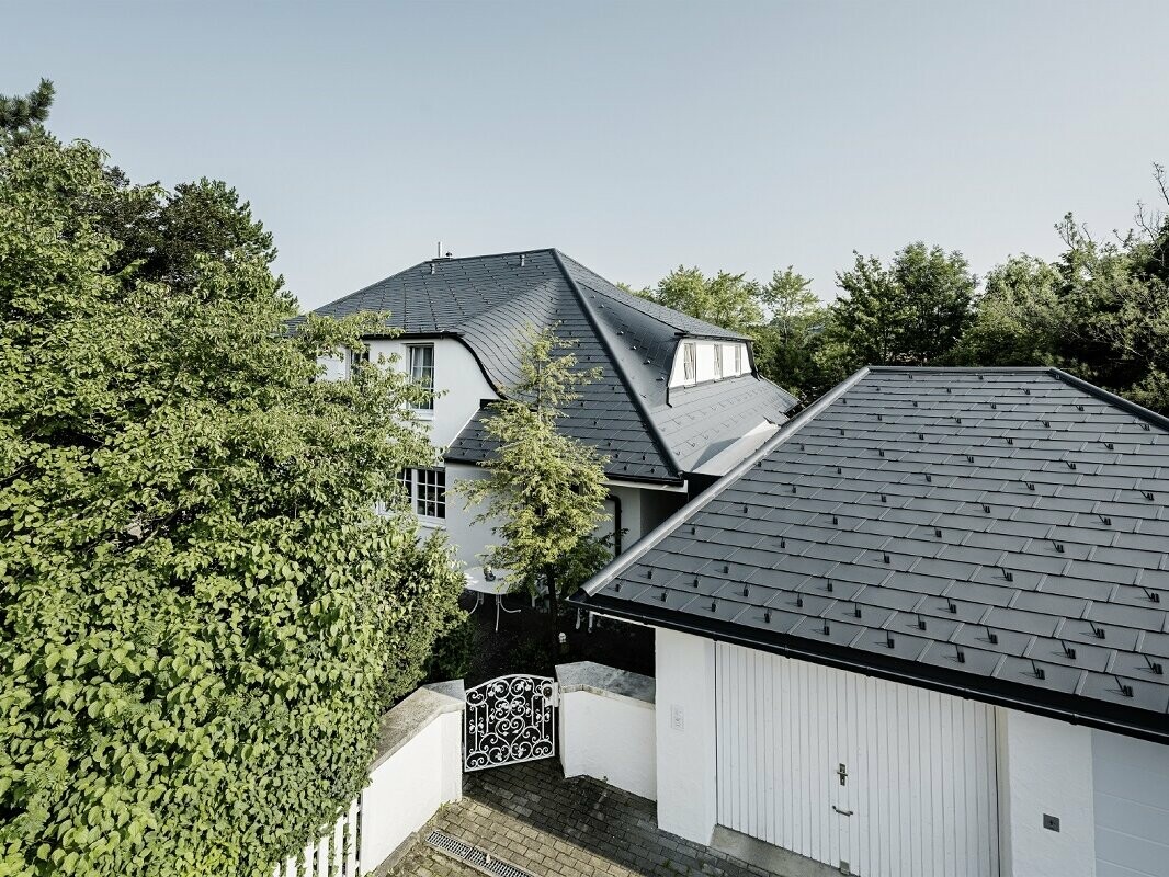 Ein Einfamilienhaus und Garage gedeckt mit der DS.19 in P.10 Anthrazit